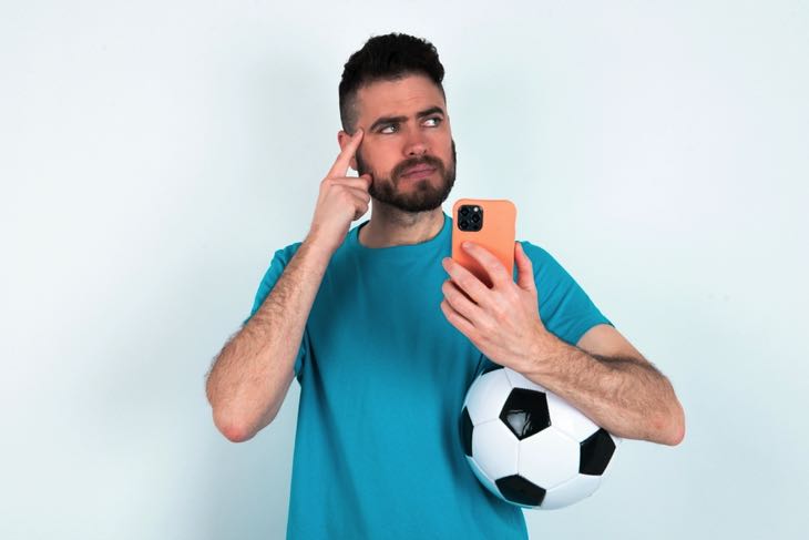 Man thinking with mobile phone